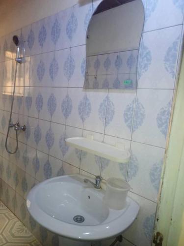 瓦加杜古YILIMDE APPARTEMENTS的浴室设有白色水槽和镜子