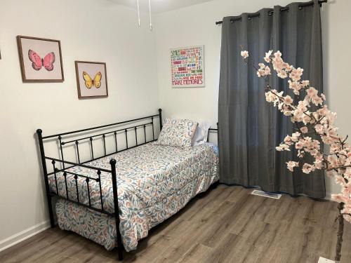 夏洛特Modern Home Near Uptown CLT, Airport and More的一间卧室设有一张床和一个鲜花窗口