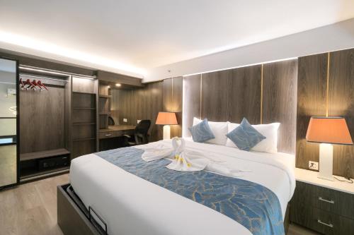 坎古Aster Apartment Bali的一间带一张大床和一张书桌的卧室和一间房间