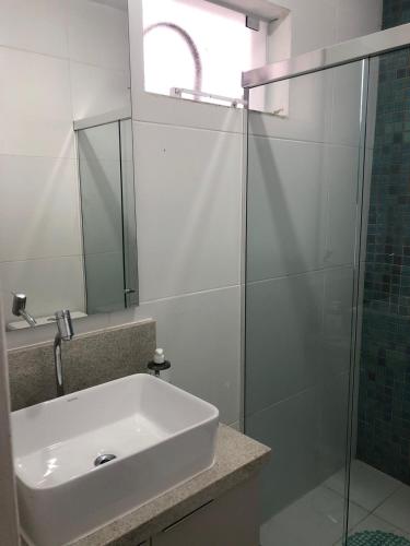 弗洛里亚诺波利斯Residencial Taiana的一间带水槽和玻璃淋浴的浴室