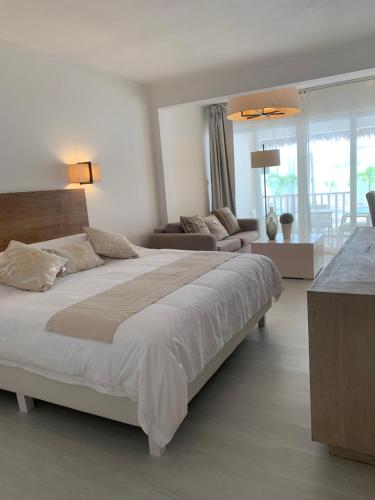 蓝海湾Le Clos des Bains Mauritius的一间带大床的卧室和一间客厅