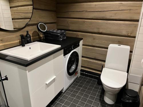 罗瓦涅米Invisible Forest Lodge的一间带水槽和洗衣机的浴室