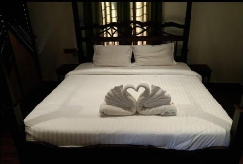 布什格尔Pushkar Guest House的白色的床,上面有心形毛巾