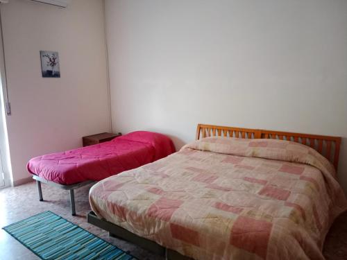 佩斯卡拉Villa di Pietro的一间卧室配有两张床,上面有粉红色的床单