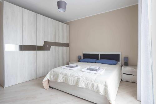 DeliaSicano Home的白色卧室配有一张白色的大床