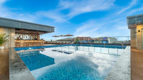 登巴萨City of Aventus Hotel - Denpasar的建筑物屋顶上的游泳池
