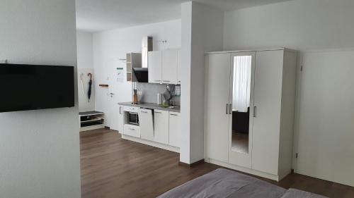 NeckarwestheimNeckarzeit的白色的厨房配有白色橱柜和冰箱。