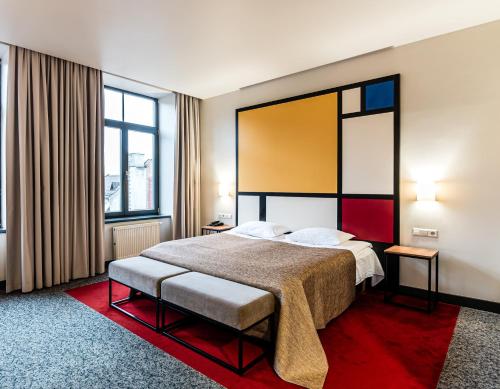 考纳斯VICTORIA Hotel Kaunas的酒店客房设有一张床和两个窗户。