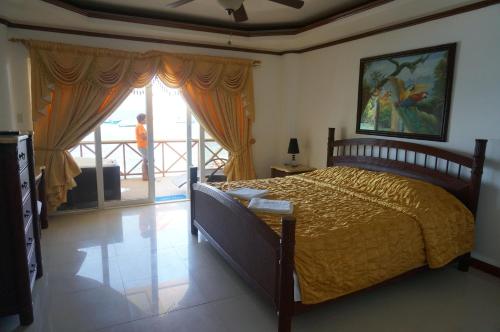 波尔多·格尼拉Lalaguna Beach Club & Dive Centre的一间卧室设有一张床和一个大窗户