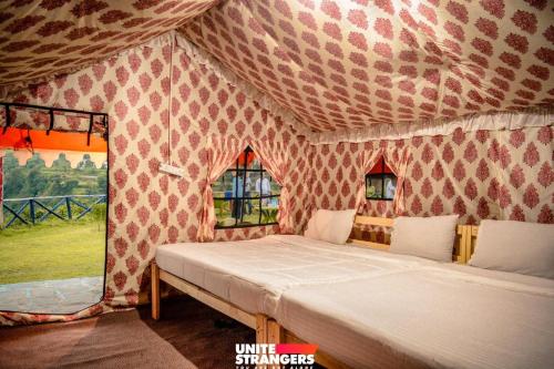奈尼塔尔Valley view camps &cottages的帐篷内一间卧室,配有一张床