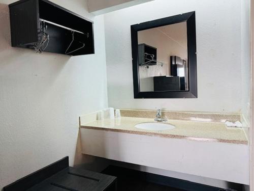 锡达拉皮兹锡达拉皮兹六号汽车旅馆的一间带水槽和镜子的浴室