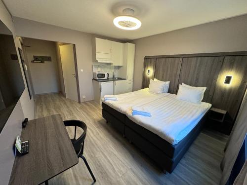 厄勒布鲁City Central Hotel Örebro by First Hotels的酒店客房配有一张床铺和一张桌子。