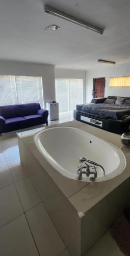 开普敦Peace and Tranquility的配有床的客房内的白色大浴缸