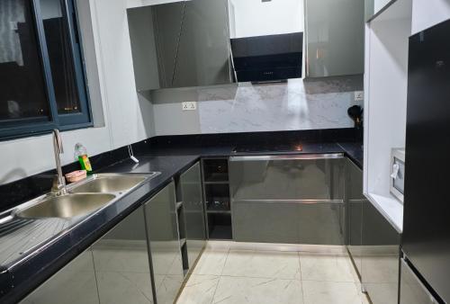 东勒贡The Pearls - Penthouse的厨房配有两个水槽和黑色台面