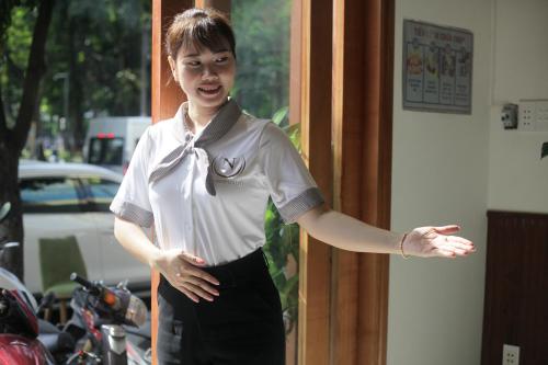 胡志明市Lantern Hotel的站在门道上的女人手臂伸出