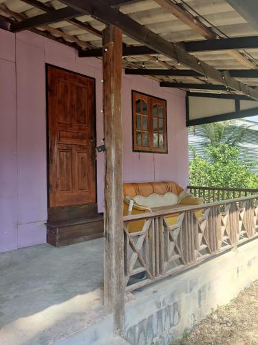 帕干岛Thai Style Housing的门廊,房子上摆着沙发