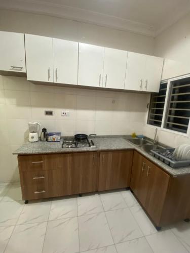莱基New 3 bedroom apartment in a private estate lekki的厨房配有白色橱柜和台面