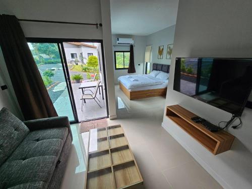 普吉镇The Hill resort Thalang的带沙发和平面电视的客厅