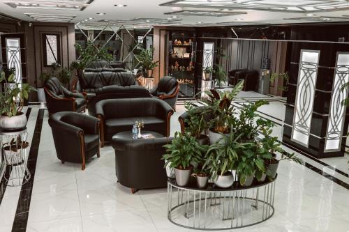塔什干ART RESIDENCE Hotel的一间设有椅子和植物的等候室