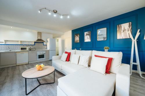 塞维利亚森特拉尔套房公寓的客厅配有白色的沙发和桌子