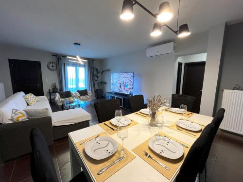 LazarétaInfinity Horizon Syros Apartment的用餐室以及带桌椅的起居室。
