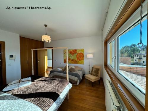 阿威罗Passadiços da Ria的一间卧室设有两张床和大窗户