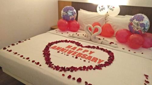 珍南海滩努美啦提酒店的一张床上有快乐的周年纪念蛋糕