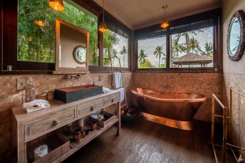 甘地达萨Villa Manis Beachfront Candidasa的带浴缸和盥洗盆的浴室