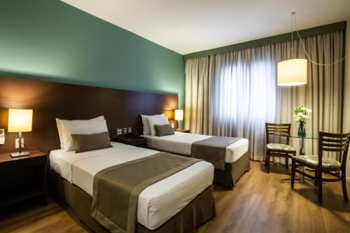 圣保罗圣保罗帕纳比酒店的酒店客房配有两张床和一张书桌