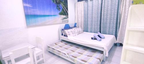 长滩岛HR's Residence的一间小卧室,配有一张床和一幅画