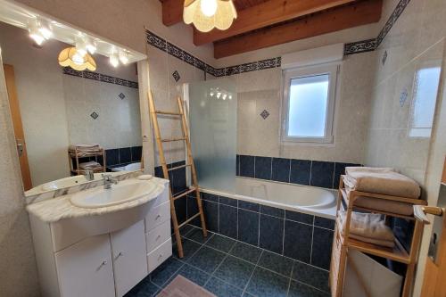 PlourhanGîte de Lourmel的浴室配有盥洗盆和浴缸。