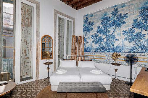 大加那利岛拉斯帕尔马斯Casa Sabai的一间卧室配有床和壁画