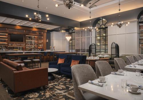 巴尔的摩巴尔的摩市中心英迪格酒店的一间带桌椅的餐厅和一间酒吧