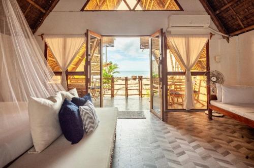 AborlanSurya Beach Resort Palawan的客厅配有白色沙发和窗户