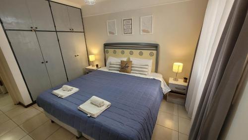 门多萨La Quinta departamento的一间卧室配有蓝色的床和毛巾