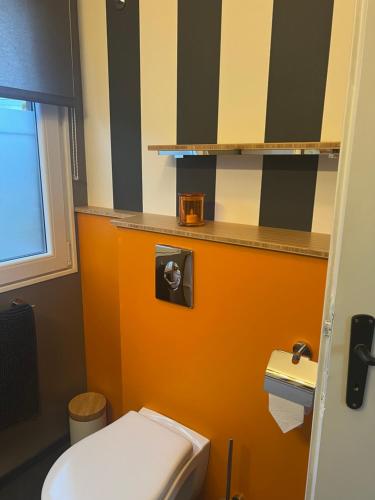 Comblain-au-PontSol Borsay - Studio de vacances à la campagne - Idéal pour 2的浴室设有白色卫生间和橙色墙壁。