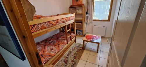 LayeLe Chamois 2的小房间设有两张双层床和一张桌子