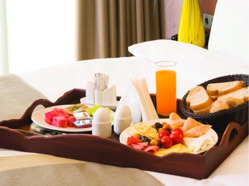 伊斯坦布尔黑斯图瑞客布鲁维酒店的床上的水果和面包托盘