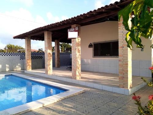 卢塞纳Casa Temporada Lucena -PB的一个带游泳池和凉亭的房子