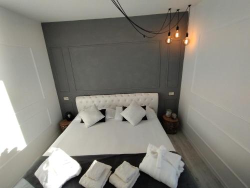 玛丽安迪安多拉Conca Verde c21- BEACH FRONT little villa- POOL, private JACUZZI sea view的卧室配有白色的床和3个枕头