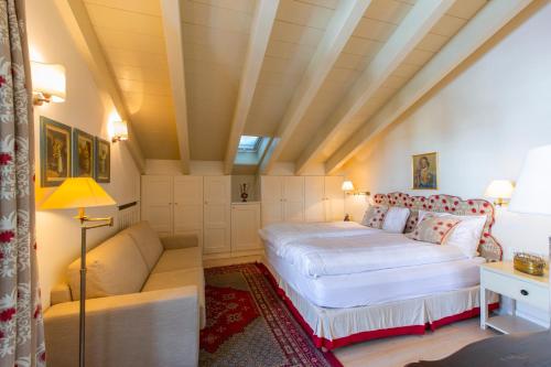 利维尼奥White Pine Lodge Livigno的一间卧室配有一张床和一张沙发