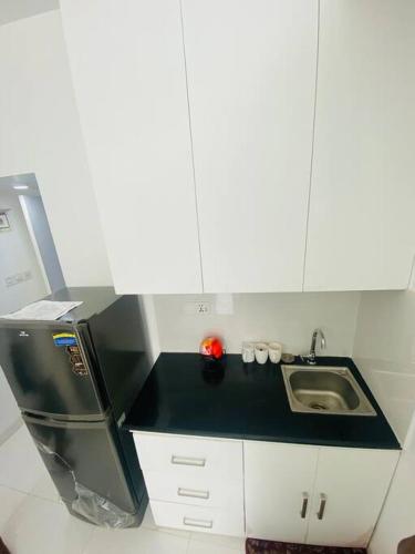 达卡Cozy Studio Apartment Basundhara的一间带水槽和冰箱的小厨房