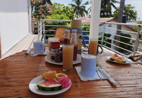 江比阿Pamoja Beach Stays Hotel in Jambiani的阳台上摆放着食品和饮料的桌子