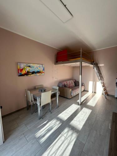 洛阿诺Centralissimo appartamento Loano的客厅配有高架床和桌子