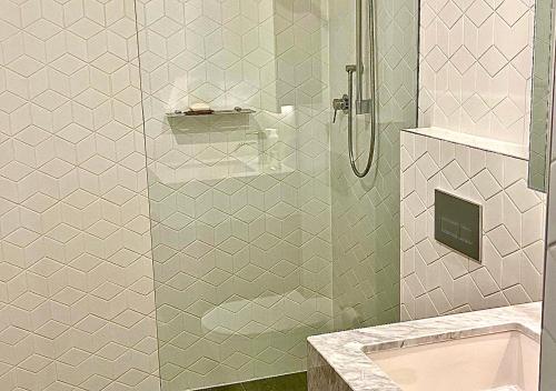 悉尼Sydney Cosmopolitan CBD Apartment的带淋浴的浴室和玻璃门