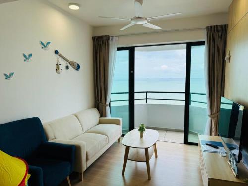 Tangga BatuMutiara Melaka Beach Resort by Minso的带沙发的客厅,享有海景