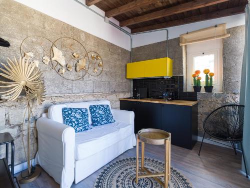 大加那利岛拉斯帕尔马斯Casa Sabai的一间带白色沙发的客厅和一间厨房