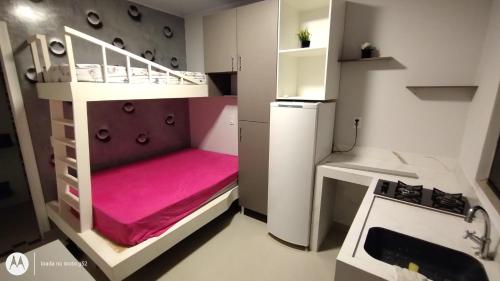 巴拉奈里奥-坎布里乌Quitinete compacta的一间小房间,配有双层床和厨房