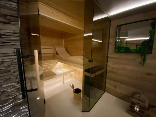 耶塞尼克Apartmány & Wellness Revenite的一间设有玻璃墙的桑拿浴室的房间