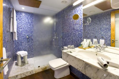 加拉奇科Hotel LIVVO La Quinta Roja的一间带水槽、卫生间和淋浴的浴室